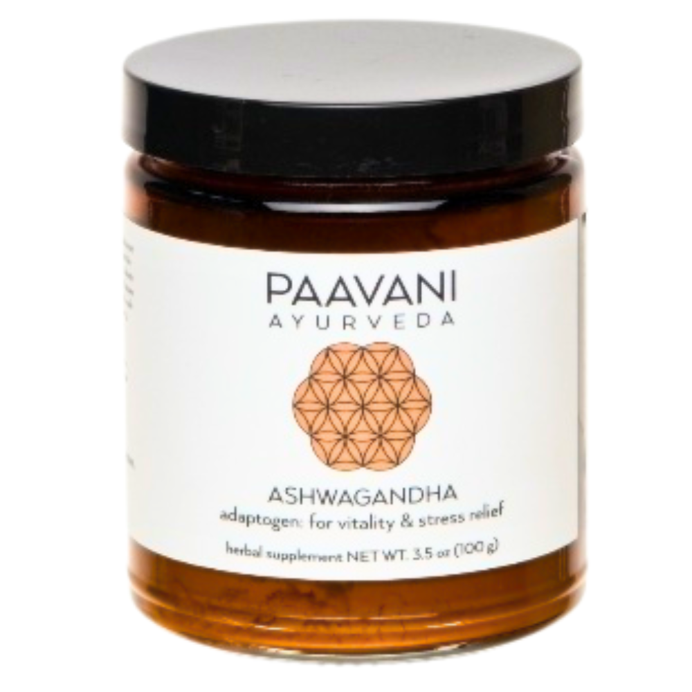 Glass jar of Paavani Ayurveda Ashwagandha Root Powder with white label, black lid, and a copper-toned sacred geometry emblem; labeled for vitality and stress relief.
