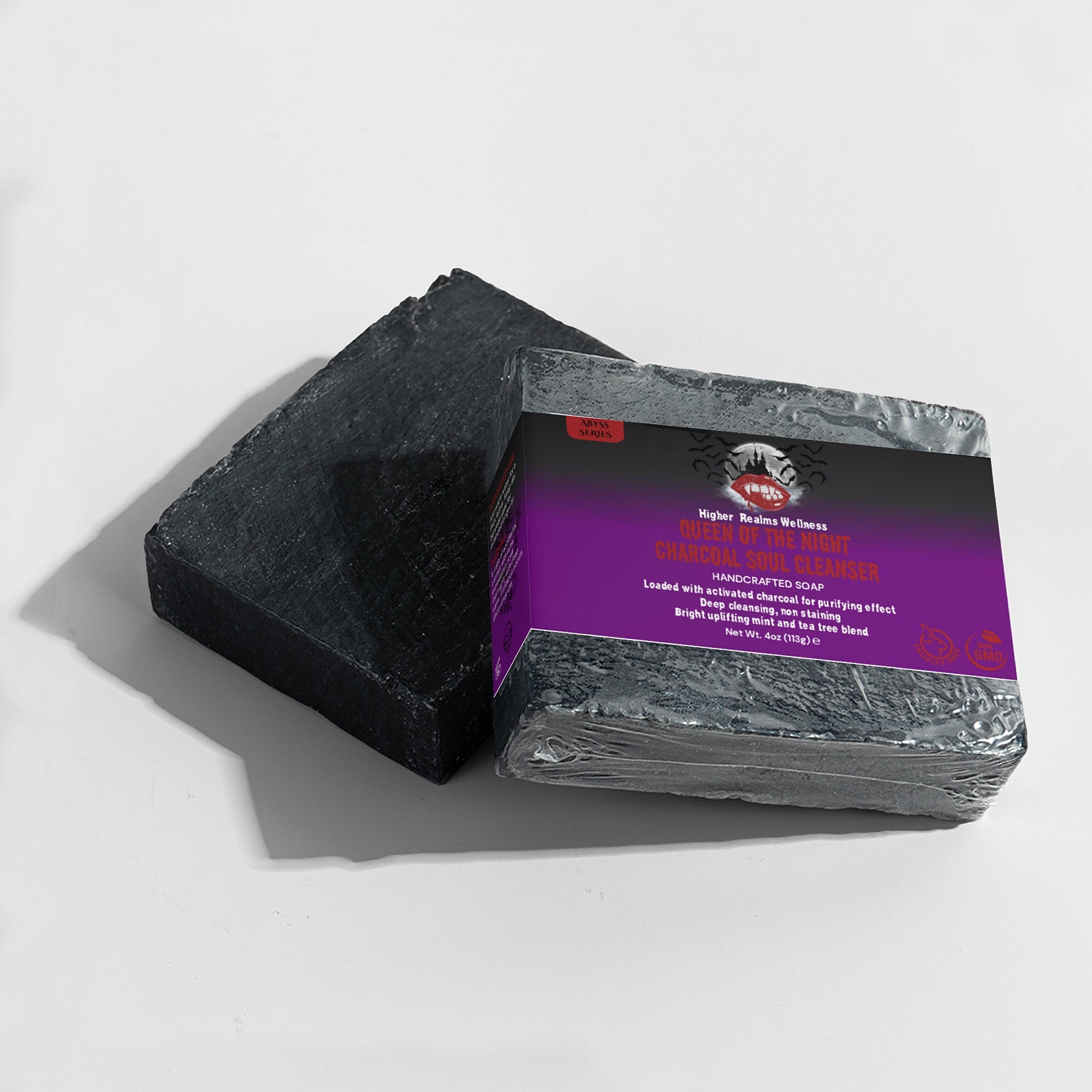 Queen of the Night charcoal soap bar by Higher Realms Wellness, featuring a black soap block with a purple and black label, displayed on a white background