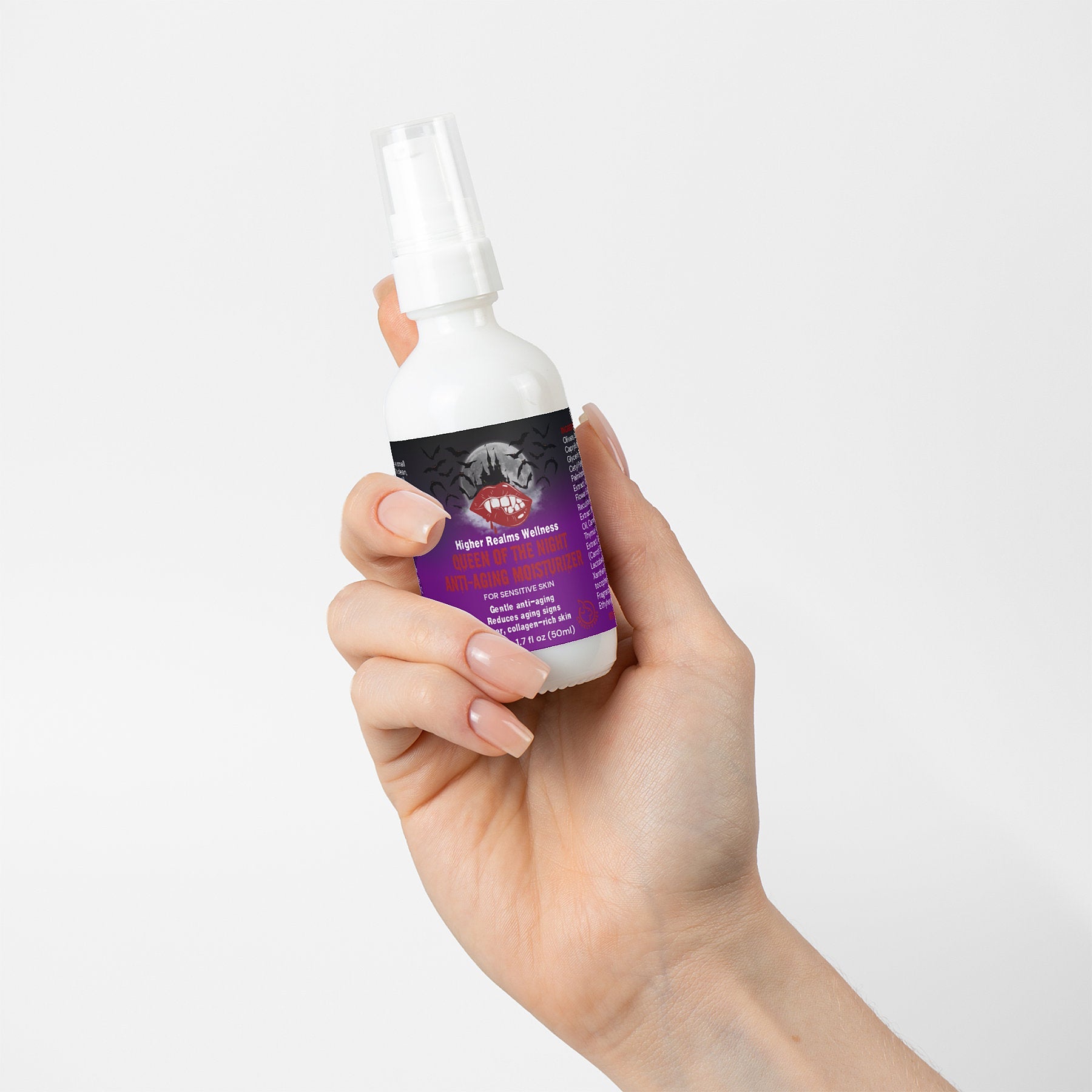 Hand holding a bottle from the Queen of the Night Skincare Bundle by Higher Realms Wellness, featuring a purple and black label against a white background