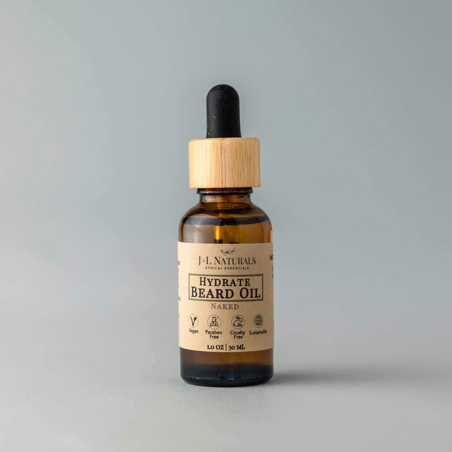 Hydrate Beard Oil by J&L Naturals in Naked scent, featuring a minimalist label and bamboo dropper against a soft grey background.