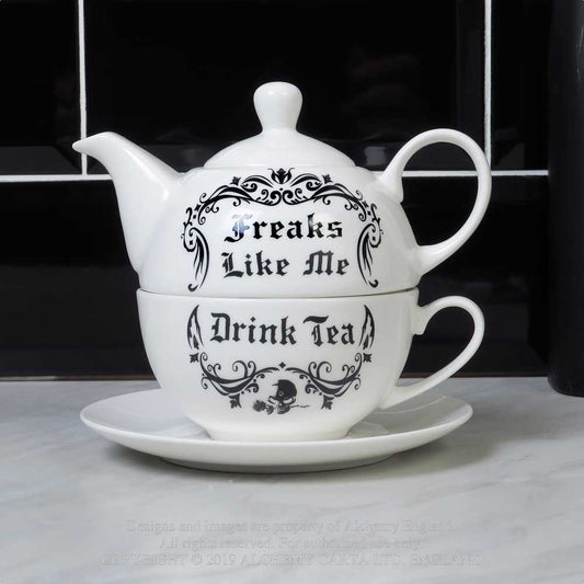 Stacked white bone china tea set with black gothic script that reads “Freaks Like Me Drink Tea,” including teapot, teacup, and saucer.